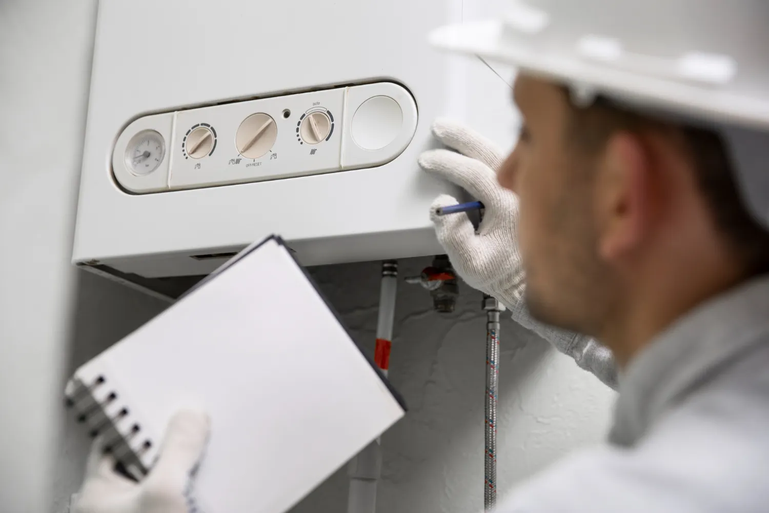 Technician performing water heater maintenance in a Minnesota home