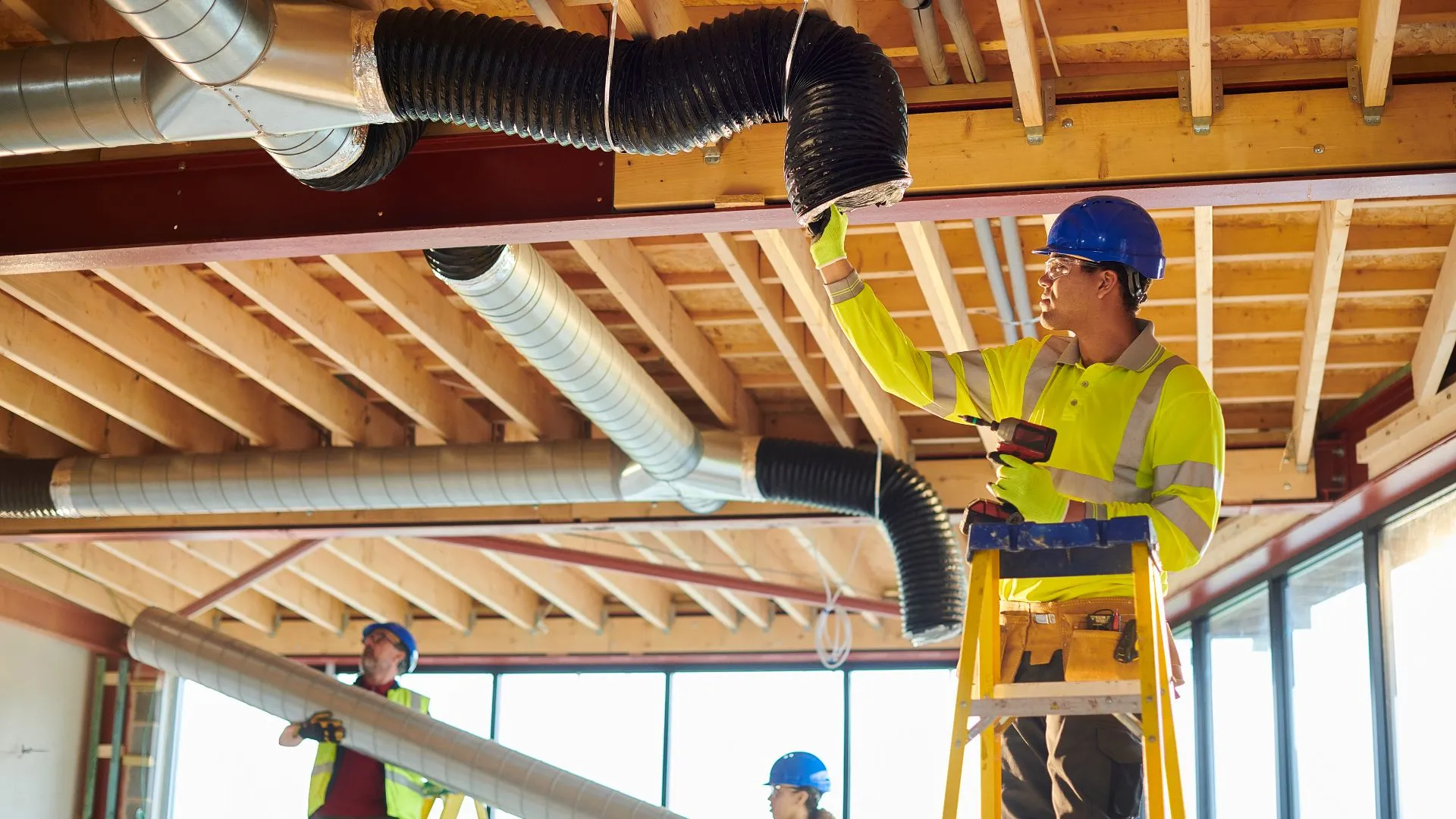 Technician installing air ducts for efficient Minnesota cooling services, Air ducts installation Minnesota – Norse Home Solutions technician at work